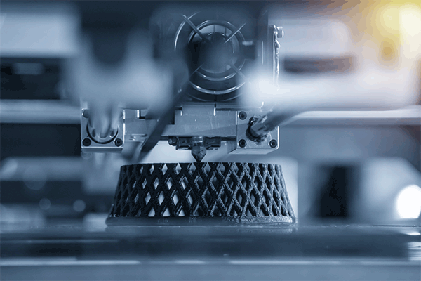 A 3D printer producing a geometric shape.